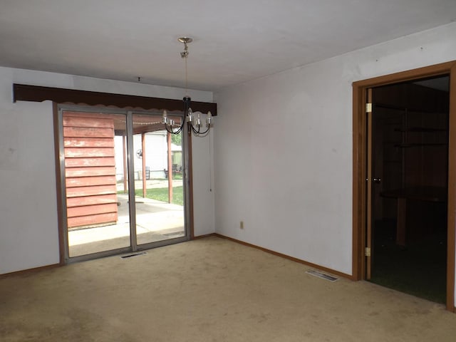 1412 11th Ave, Sterling, IL 61081 - carpeted empty room with a chandelier and baseboards
