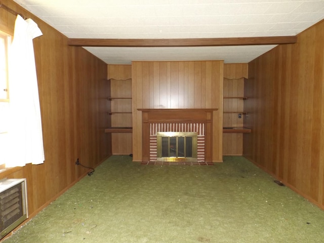 1412 11th Ave, Sterling, IL 61081 - unfurnished living room with wooden walls, a brick fireplace, and carpet flooring