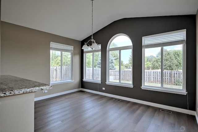 2141 Bluemist Dr, Aurora, IL 60504 - unfurnished dining area featuring plenty of natural light, dark wood-style flooring, vaulted ceiling, and a chandelier