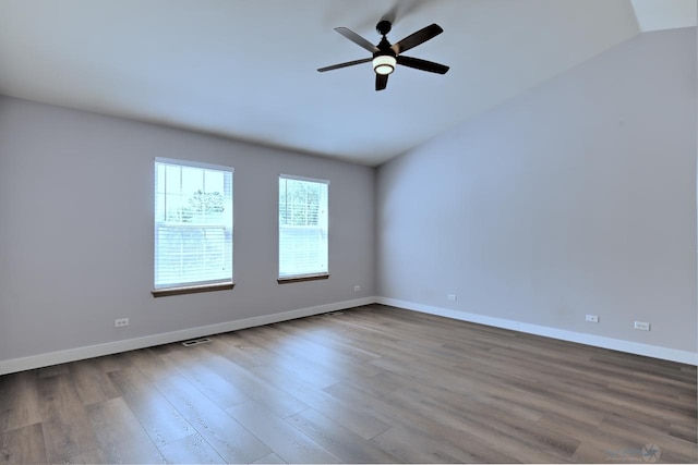 2141 Bluemist Dr, Aurora, IL 60504 - spare room featuring wood finished floors, vaulted ceiling, and ceiling fan