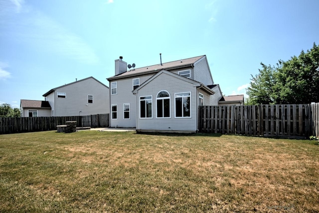 2141 Bluemist Dr, Aurora, IL 60504 - back of house with a chimney, a fenced backyard, and a patio area