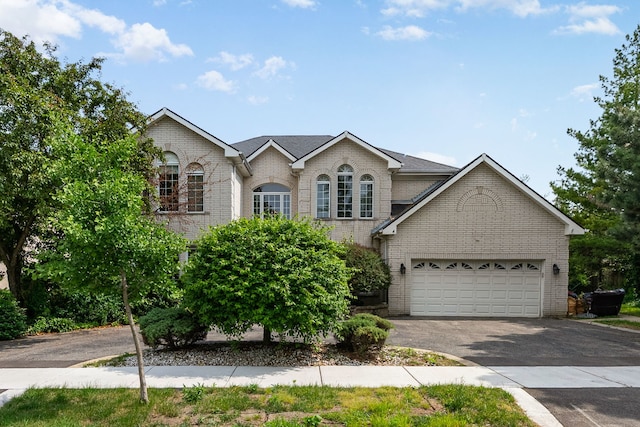 201 E White Oak St, Arlington Heights, IL 60005 - traditional home featuring brick siding, asphalt driveway, and an attached garage