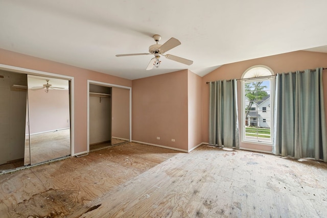 201 E White Oak St, Arlington Heights, IL 60005 - unfurnished bedroom with two closets, vaulted ceiling, and a ceiling fan