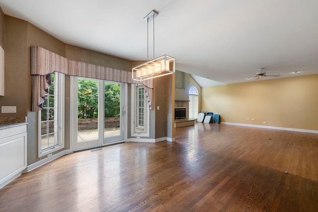 201 E White Oak St, Arlington Heights, IL 60005 - unfurnished living room with wood finished floors, a brick fireplace, ceiling fan, and vaulted ceiling