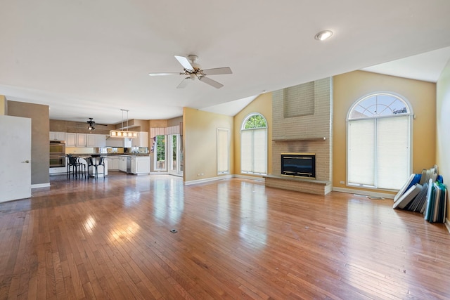 201 E White Oak St, Arlington Heights, IL 60005 - unfurnished living room featuring vaulted ceiling, ceiling fan, wood-type flooring, and a fireplace