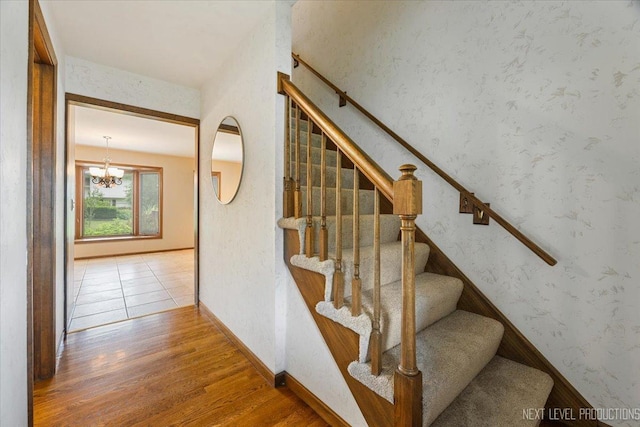 1054 Maple Ln, Batavia, IL 60510 - staircase featuring wood finished floors, a chandelier, and wallpapered walls