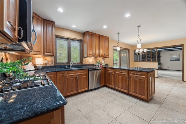 1054 Maple Ln, Batavia, IL 60510 - kitchen with appliances with stainless steel finishes, a chandelier, brown cabinetry, a peninsula, and backsplash