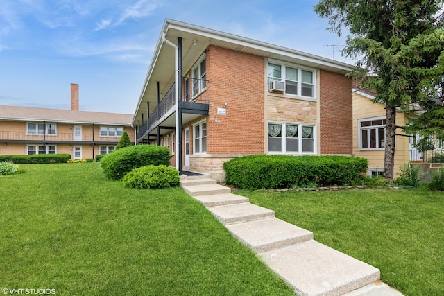 7268 W Thorndale Ave Unit 8A, Chicago, IL 60631 - view of front of home featuring a front lawn, a balcony, cooling unit, and brick siding