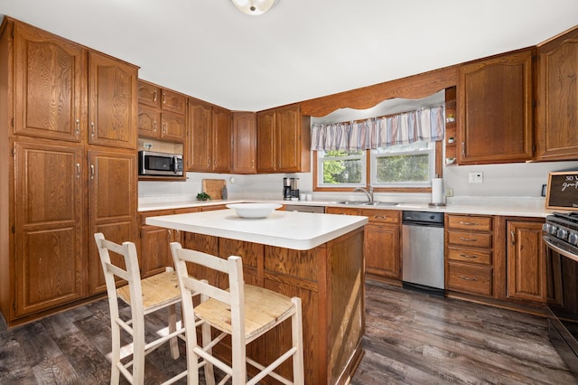 15181 Willow Run Dr, Dekalb, IL 60115 - kitchen with stainless steel microwave, stove, dark wood-type flooring, light countertops, and a center island