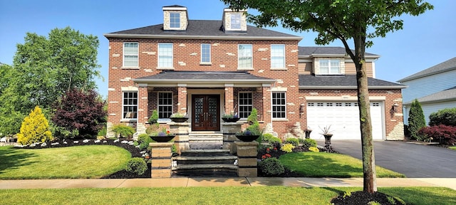 3004 Wayland Ave, Elgin, IL 60124 - view of front facade with asphalt driveway, brick siding, french doors, and an attached garage