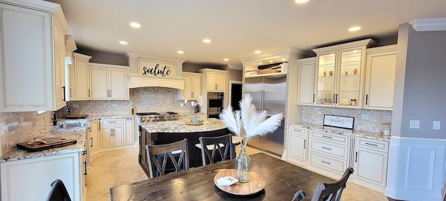 3004 Wayland Ave, Elgin, IL 60124 - kitchen with stainless steel appliances, backsplash, recessed lighting, light stone countertops, and a kitchen island