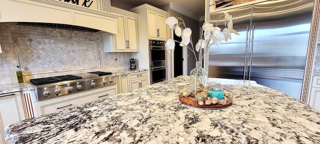 3004 Wayland Ave, Elgin, IL 60124 - kitchen with stainless steel appliances, custom exhaust hood, light stone counters, tasteful backsplash, and crown molding