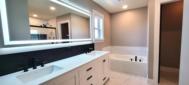 3004 Wayland Ave, Elgin, IL 60124 - bathroom with marble finish floors, a bath, a shower stall, tasteful backsplash, and double vanity