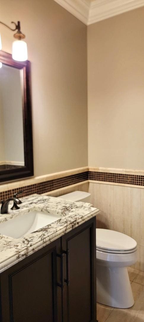 3004 Wayland Ave, Elgin, IL 60124 - half bathroom with ornamental molding, vanity, a wainscoted wall, tile walls, and tile patterned flooring