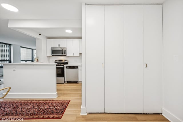 440 N Wabash Ave Unit 1908, Chicago, IL 60611 - kitchen featuring stainless steel appliances, light wood finished floors, white cabinetry, light countertops, and recessed lighting
