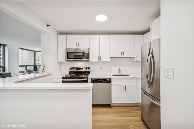 440 N Wabash Ave Unit 1908, Chicago, IL 60611 - kitchen featuring appliances with stainless steel finishes, white cabinetry, and light countertops