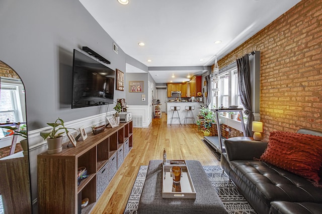 4825 N Karlov Ave, Chicago, IL 60630 - living area featuring a wainscoted wall, light wood-style floors, recessed lighting, and brick wall