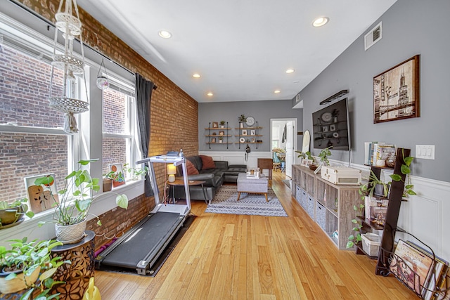 4825 N Karlov Ave, Chicago, IL 60630 - living room with wood finished floors, wainscoting, recessed lighting, and brick wall