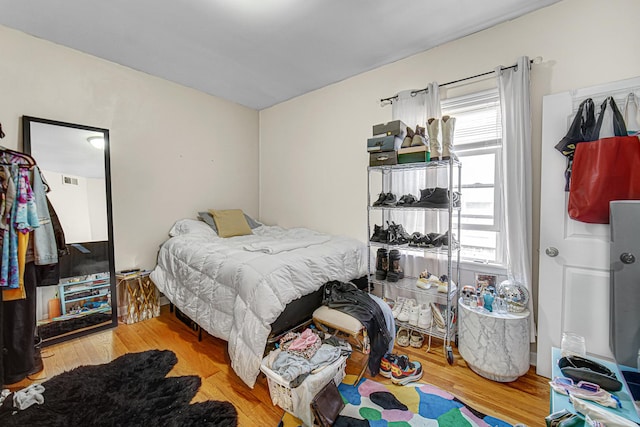 4825 N Karlov Ave, Chicago, IL 60630 - bedroom featuring multiple windows and wood finished floors