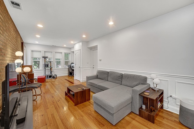 4825 N Karlov Ave, Chicago, IL 60630 - living area featuring light wood-type flooring, wainscoting, a decorative wall, and recessed lighting