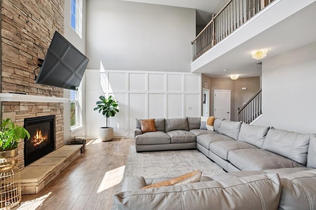 26930 Thornwood Blvd, Plainfield, IL 60585 - living room with a towering ceiling, hardwood / wood-style flooring, a fireplace, and stairway