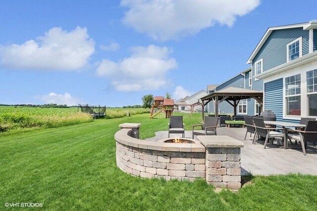 26930 Thornwood Blvd, Plainfield, IL 60585 - view of grassy yard with a gazebo, an outdoor fire pit, a patio area, and a playground