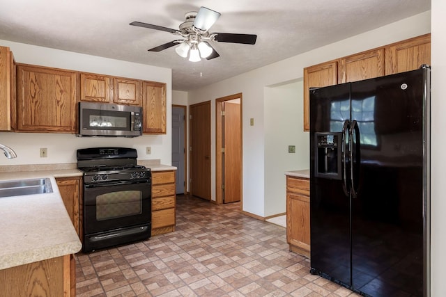 5971 Whispering Way, Loves Park, IL 61111 - kitchen featuring black appliances, light countertops, ceiling fan, brown cabinetry, and brick patterned flooring