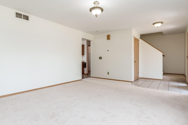 5971 Whispering Way, Loves Park, IL 61111 - unfurnished room with light colored carpet, stairway, and light tile patterned flooring