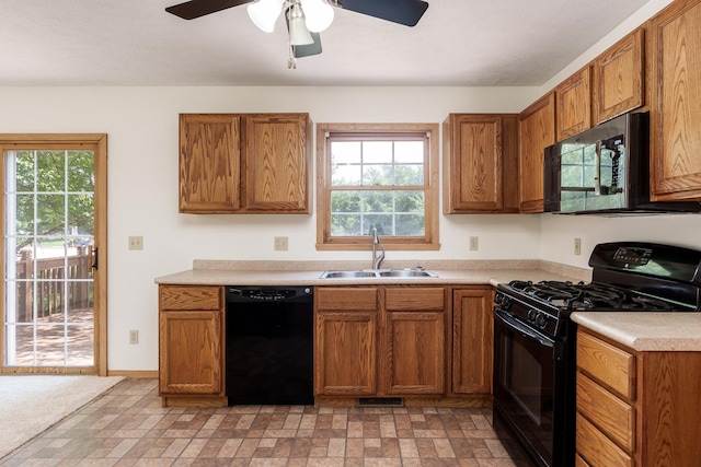 5971 Whispering Way, Loves Park, IL 61111 - kitchen with black appliances, healthy amount of natural light, light countertops, and brick patterned floors