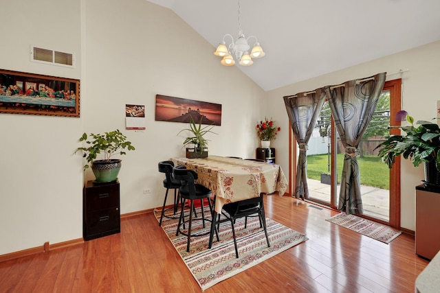1565 Stefanie Ln, Bourbonnais, IL 60914 - dining room with a chandelier, high vaulted ceiling, and wood finished floors