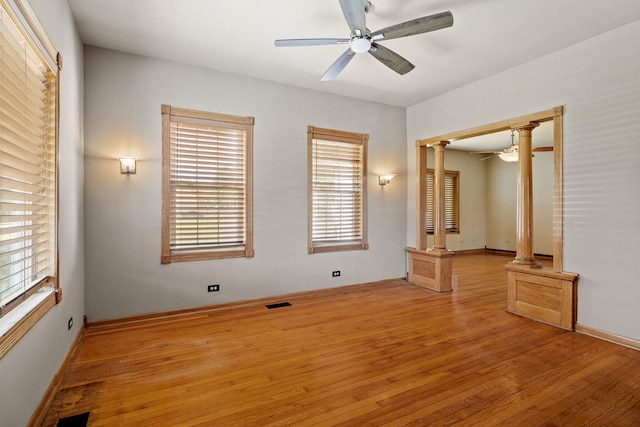 26050 S Locust Pl, Monee, IL 60449 - empty room featuring ornate columns, ceiling fan, and wood-type flooring