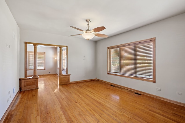 26050 S Locust Pl, Monee, IL 60449 - spare room with a ceiling fan, decorative columns, and light wood-type flooring