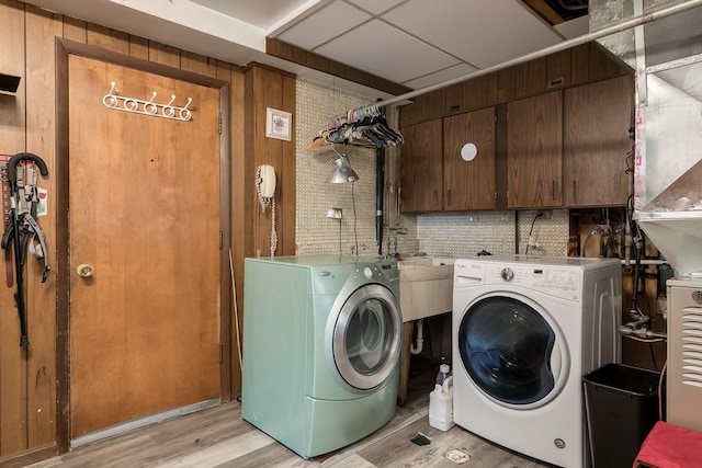 9S339 Cumnor Rd, Downers Grove, IL 60516 - washroom with washer and dryer, light wood-style floors, and cabinet space