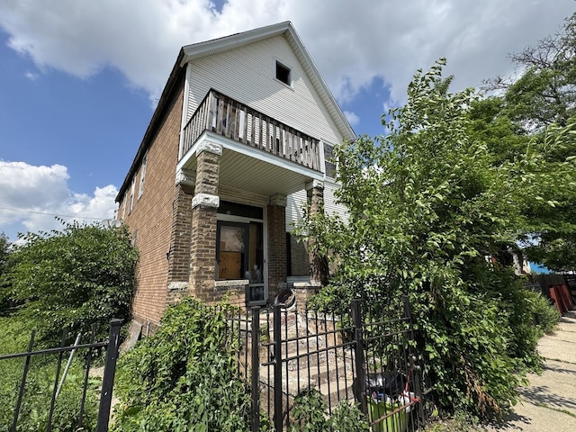 4022 W Carroll Ave, Chicago, IL 60624 - view of front of home with a balcony, brick siding, and covered porch