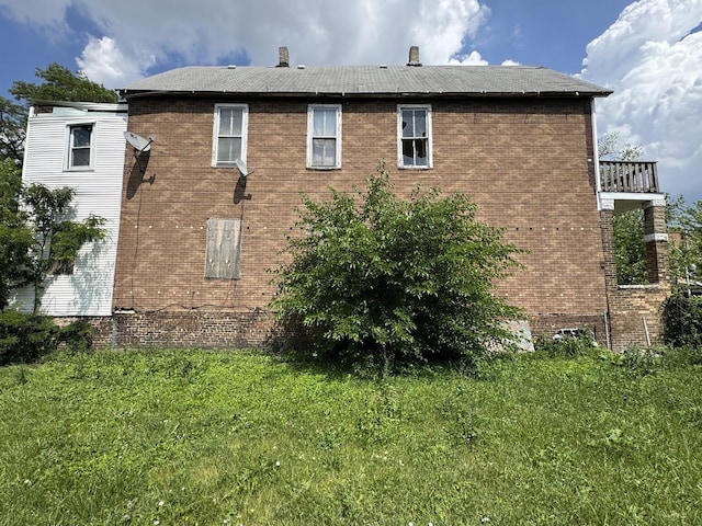 4022 W Carroll Ave, Chicago, IL 60624 - view of side of property with brick siding, a lawn, and a balcony