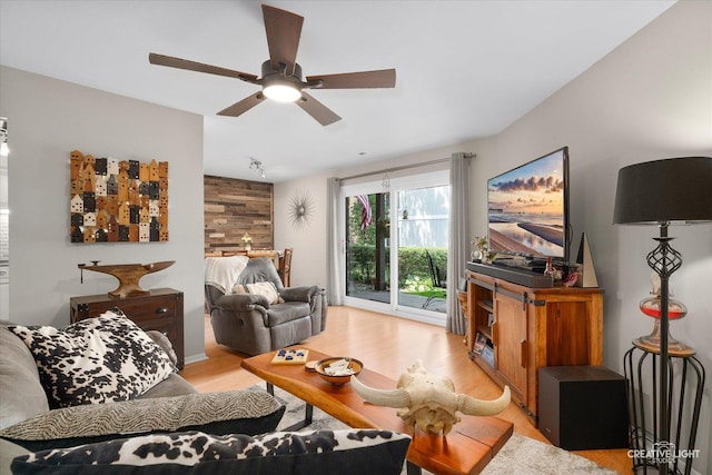1703 Lakecliffe Dr Unit D, Wheaton, IL 60189 - living room featuring a ceiling fan, light wood-type flooring, and wooden walls