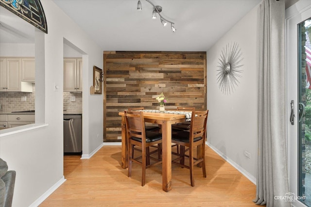 1703 Lakecliffe Dr Unit D, Wheaton, IL 60189 - dining room featuring light wood-style floors, wood walls, and rail lighting