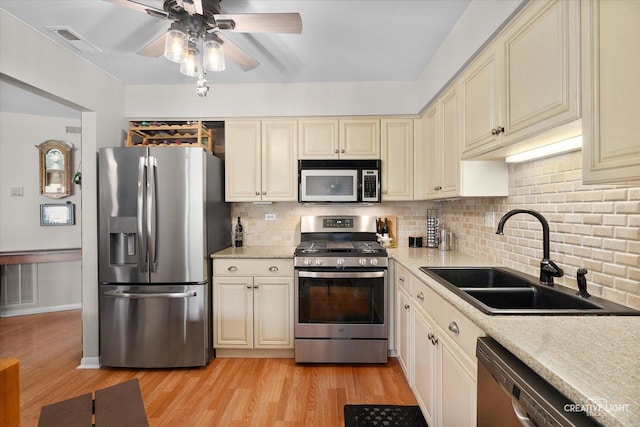 1703 Lakecliffe Dr Unit D, Wheaton, IL 60189 - kitchen featuring stainless steel appliances, cream cabinetry, a ceiling fan, and light wood-style floors