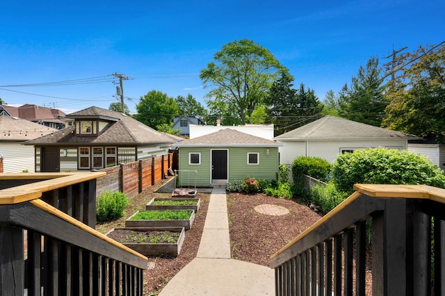 638 S Cuyler Ave, Oak Park, IL 60304 - view of front of home with a vegetable garden, a fenced backyard, and an outbuilding