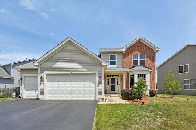 2590 Hennig Rd, Hampshire, IL 60140 - traditional-style home featuring an attached garage and asphalt driveway