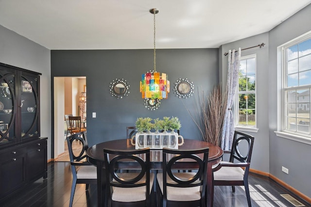 2590 Hennig Rd, Hampshire, IL 60140 - dining area with dark wood-type flooring and baseboards