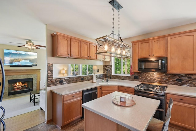 2590 Hennig Rd, Hampshire, IL 60140 - kitchen featuring appliances with stainless steel finishes, light countertops, ceiling fan, backsplash, and hanging light fixtures