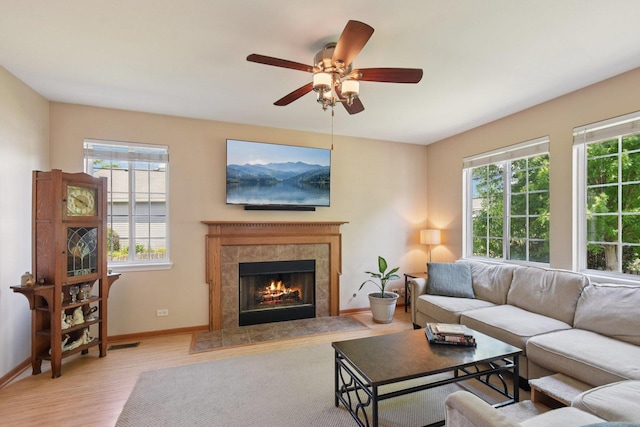 2590 Hennig Rd, Hampshire, IL 60140 - living room featuring light wood-style flooring, a fireplace, and ceiling fan