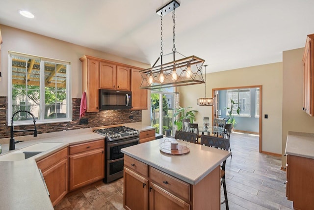 2590 Hennig Rd, Hampshire, IL 60140 - kitchen featuring black microwave, double oven range, tasteful backsplash, light countertops, and decorative light fixtures