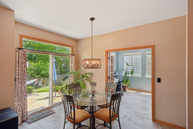 2590 Hennig Rd, Hampshire, IL 60140 - dining space featuring a chandelier and baseboards
