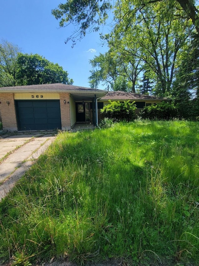 569 Lakewood Blvd, Park Forest, IL 60466 - view of front of property with brick siding, a garage, and driveway
