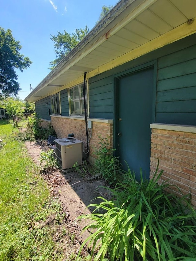 569 Lakewood Blvd, Park Forest, IL 60466 - view of side of home with a central air condition unit and brick siding
