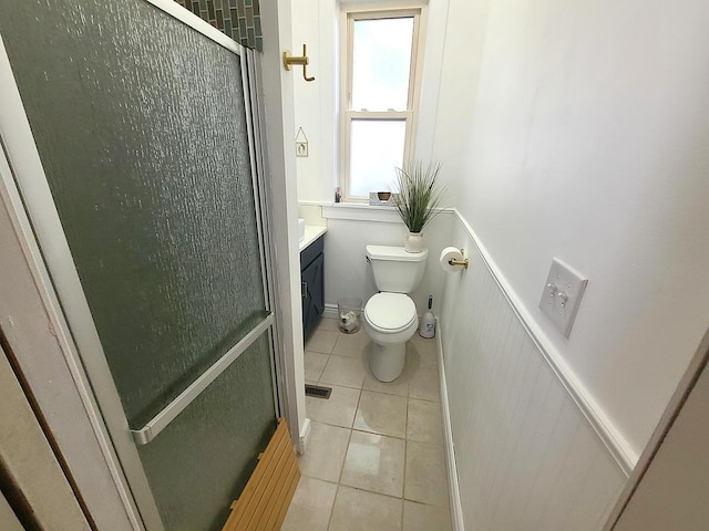 313 S 4th St, Oregon, IL 61061 - bathroom with tile patterned floors, a shower stall, vanity, and wainscoting
