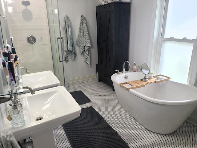 313 S 4th St, Oregon, IL 61061 - bathroom with a freestanding tub, a shower stall, and tile patterned floors