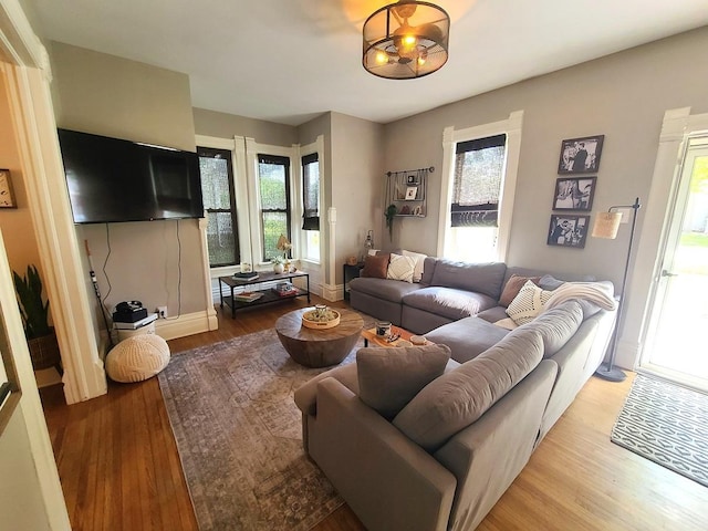 313 S 4th St, Oregon, IL 61061 - living room featuring wood finished floors, healthy amount of natural light, and a chandelier